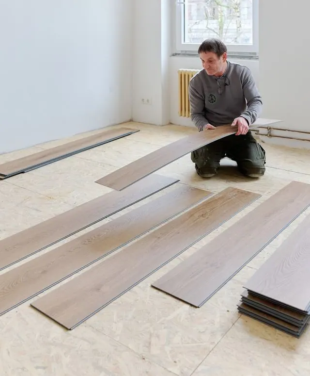 Fitter laying out planks from several boxes