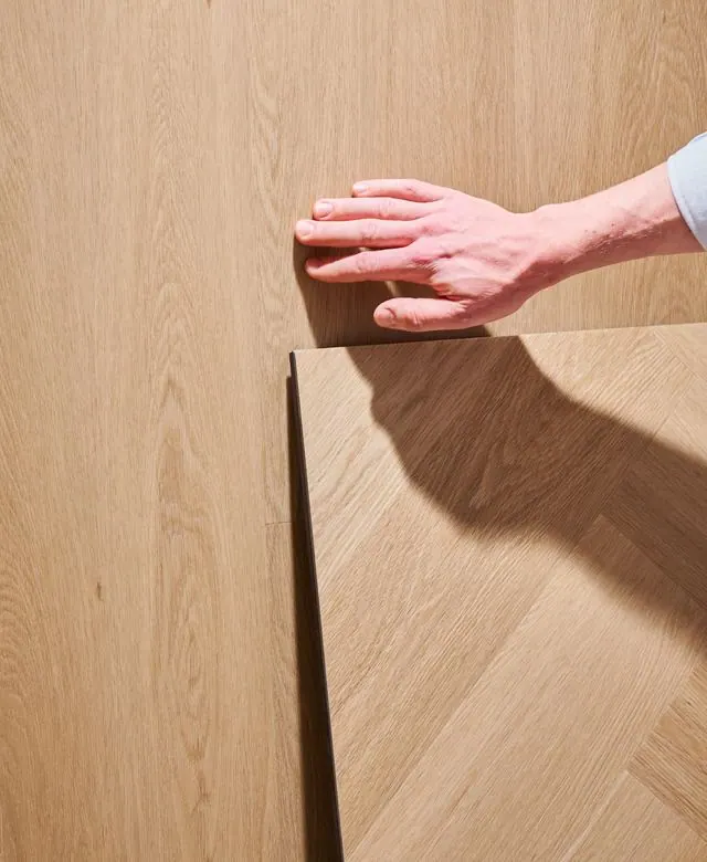 Hand on a sample plank